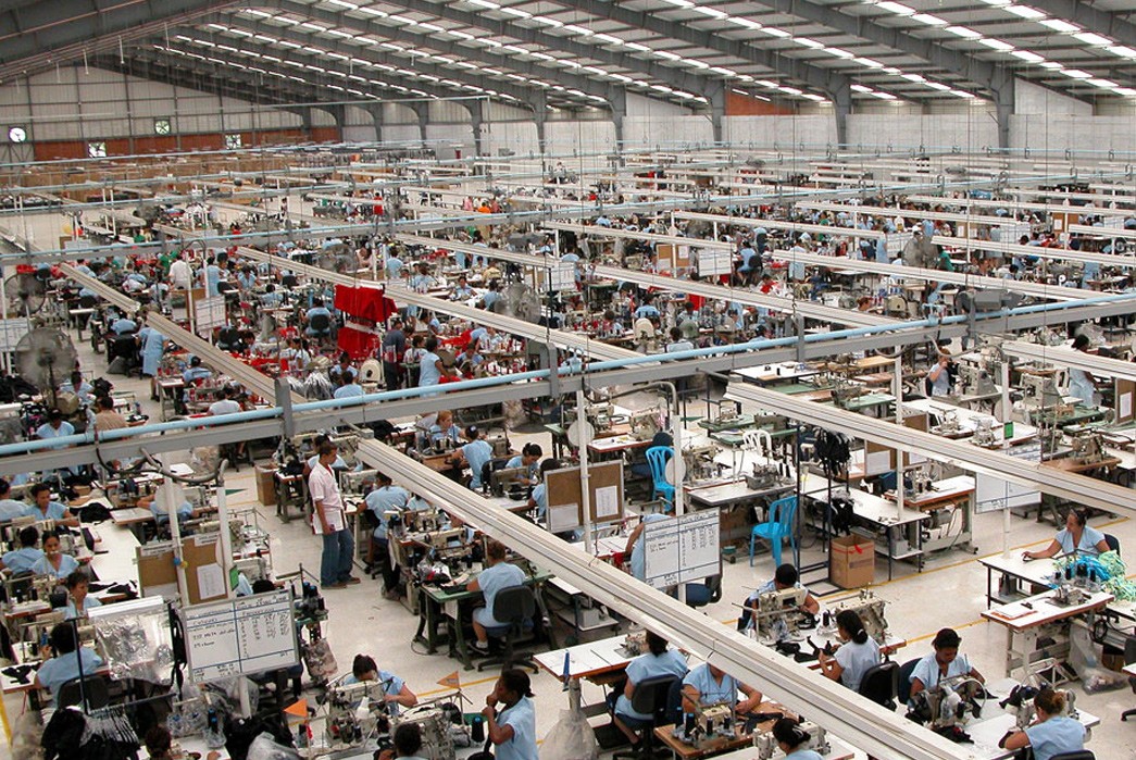 Background image of a modern manufacturing facility